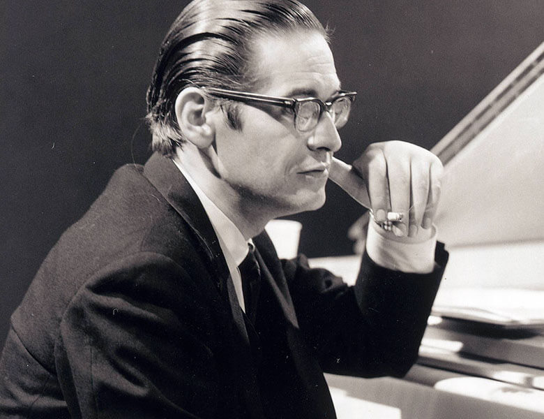Photo of Bill Evans sitting at the piano